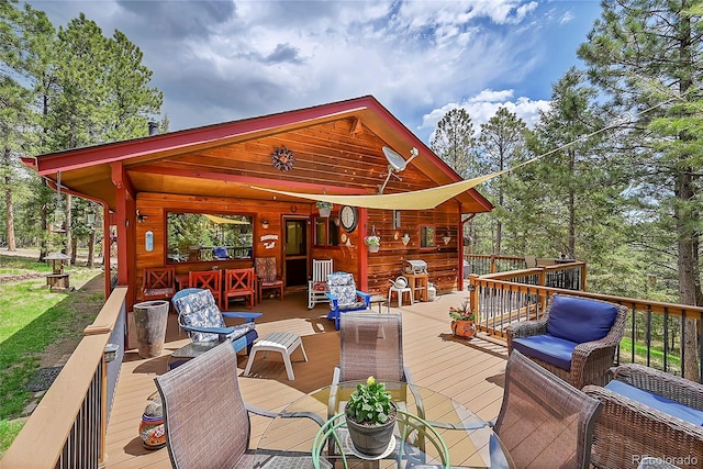 wooden terrace featuring a grill and an outdoor hangout area