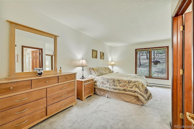 bedroom with baseboard heating, a textured ceiling, and light colored carpet