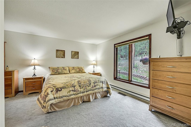 bedroom with a textured ceiling and light colored carpet