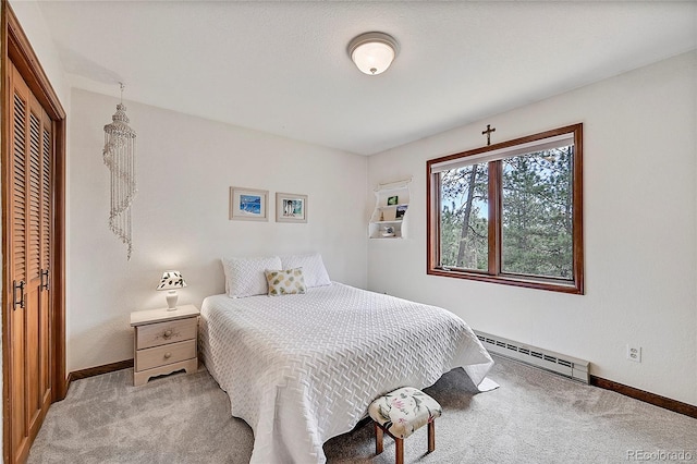 bedroom featuring a baseboard radiator, a closet, and light colored carpet