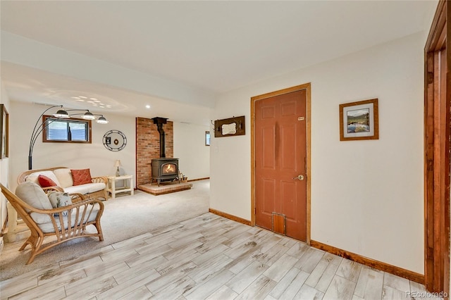 living area featuring a wood stove, light colored carpet, and brick wall