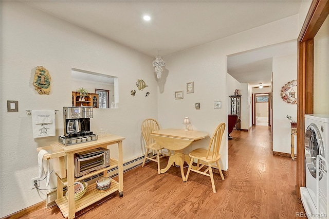 dining area featuring washer / clothes dryer and light hardwood / wood-style floors