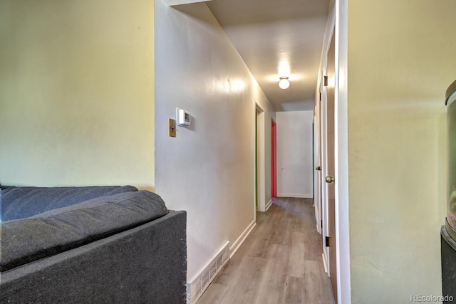 hallway with light hardwood / wood-style flooring