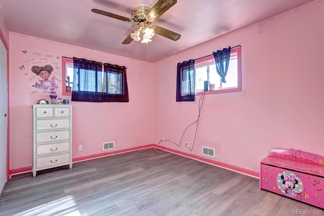 unfurnished bedroom with wood-type flooring and ceiling fan