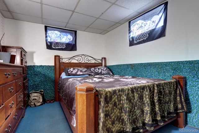 bedroom with carpet flooring and a drop ceiling