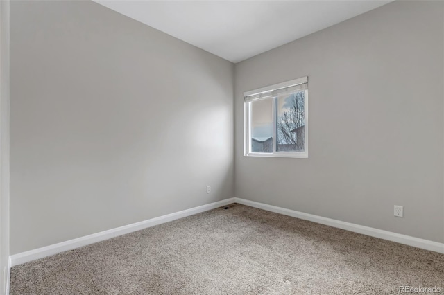 unfurnished room with carpet floors and baseboards