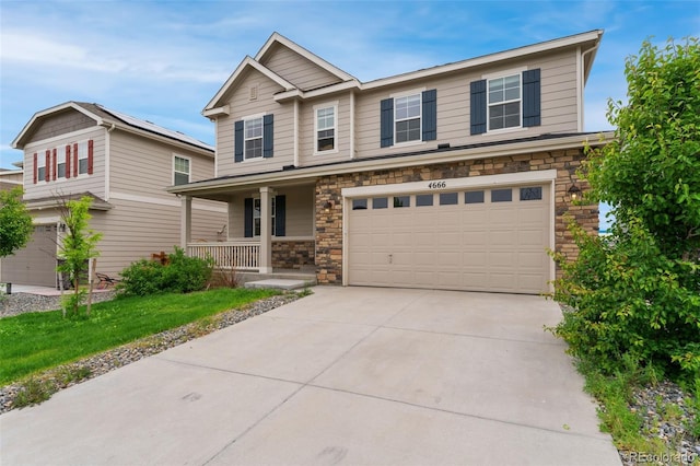4666 S Malaya Ct, Aurora, CO 80015 - craftsman-style home with a porch, stone siding, an attached garage, and driveway