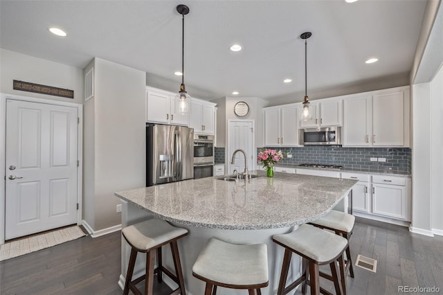 kitchen featuring white cabinetry, dark wood-style flooring, appliances with stainless steel finishes, and a sink