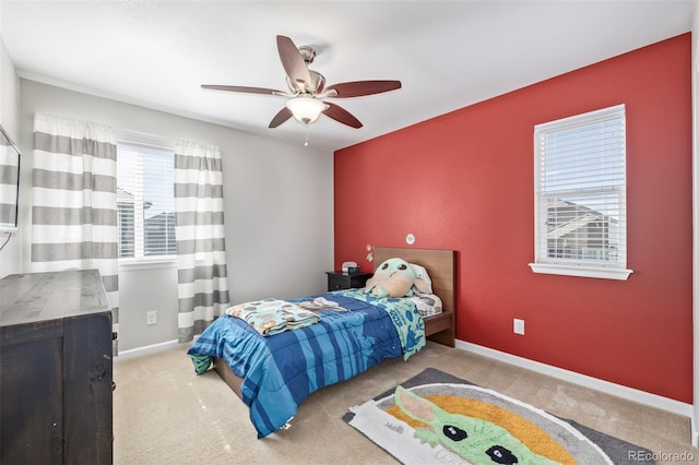 carpeted bedroom with baseboards and a ceiling fan