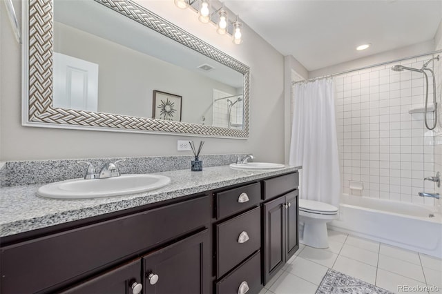 full bathroom with tile patterned flooring, double vanity, toilet, and a sink