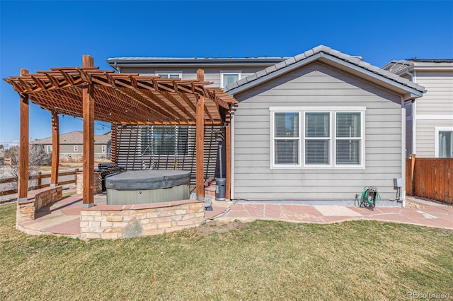 back of property featuring a patio area, a lawn, a pergola, and a hot tub