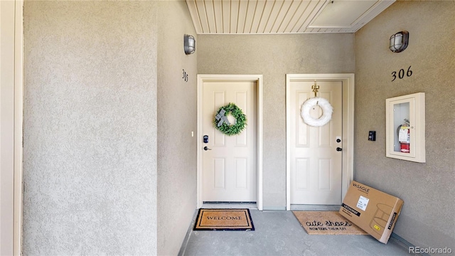 view of exterior entry with stucco siding