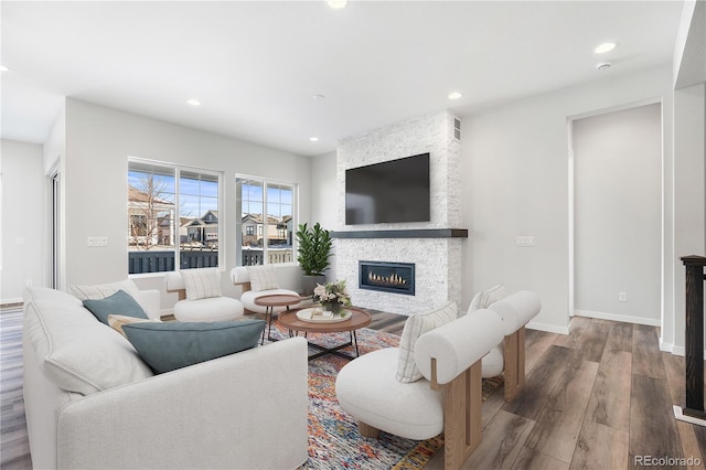 living room with a fireplace and hardwood / wood-style flooring