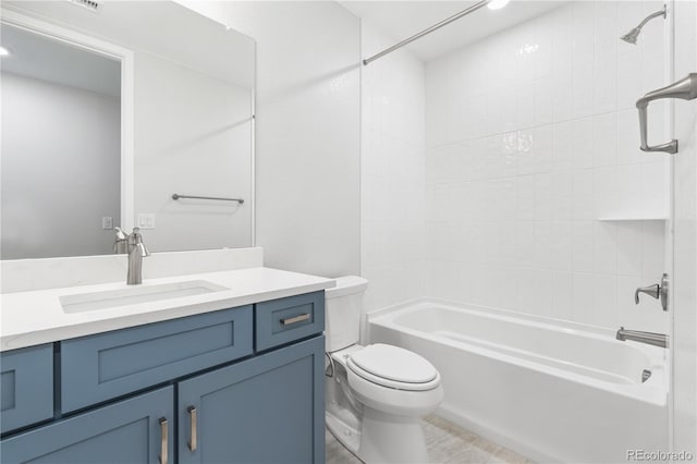 full bathroom with toilet, vanity, and tiled shower / bath combo