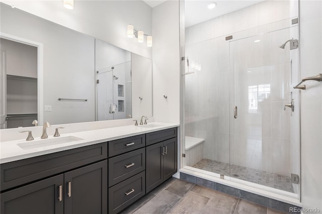 bathroom with a shower with door and vanity