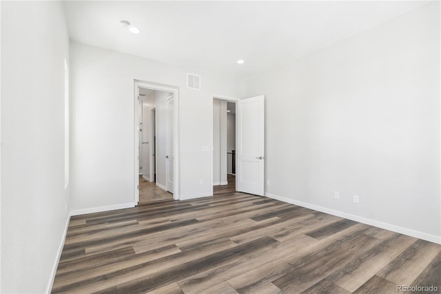 unfurnished bedroom with dark hardwood / wood-style flooring