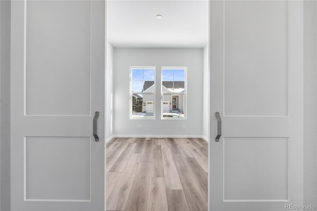 corridor with light hardwood / wood-style flooring