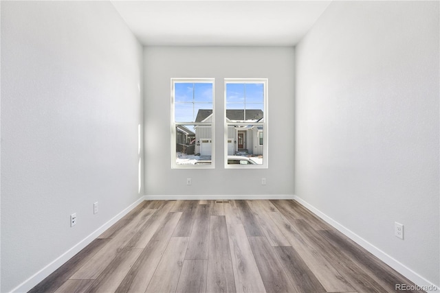 unfurnished room with light wood-type flooring