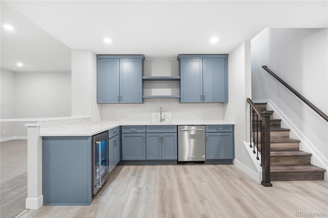 kitchen with dishwasher, light hardwood / wood-style floors, kitchen peninsula, sink, and beverage cooler