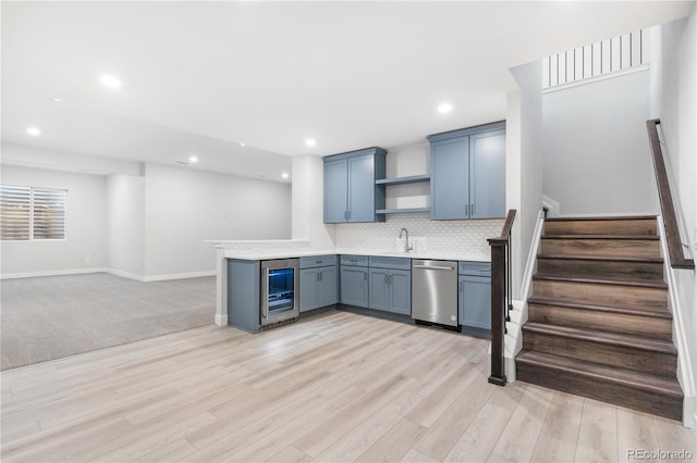 kitchen with wine cooler, light hardwood / wood-style floors, sink, backsplash, and stainless steel dishwasher