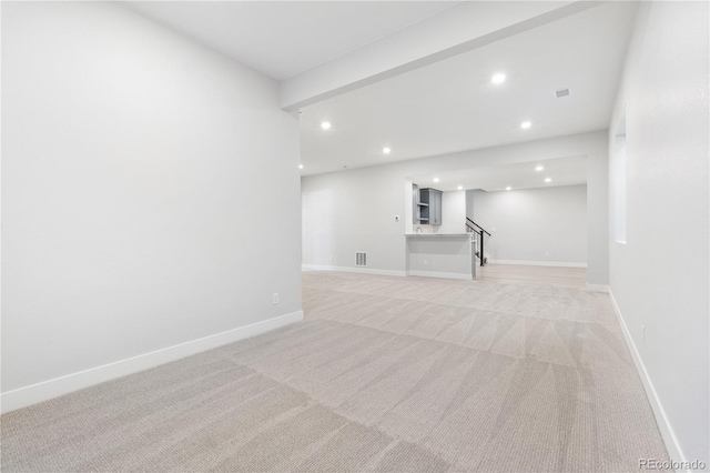 unfurnished living room with light colored carpet