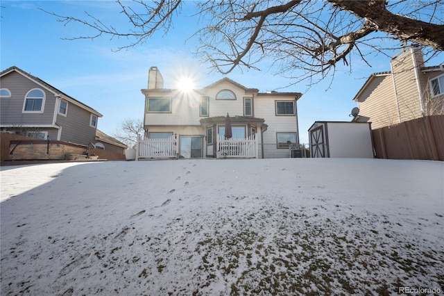 view of snow covered rear of property