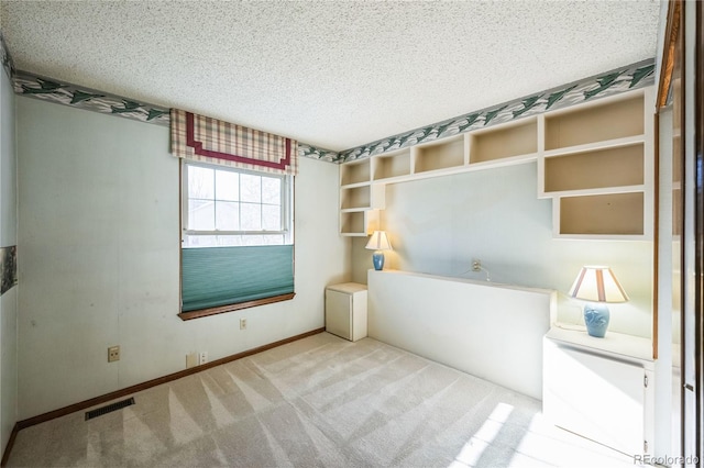 unfurnished bedroom featuring a textured ceiling and carpet flooring