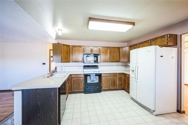 kitchen with kitchen peninsula, electric stove, dishwasher, white fridge with ice dispenser, and sink