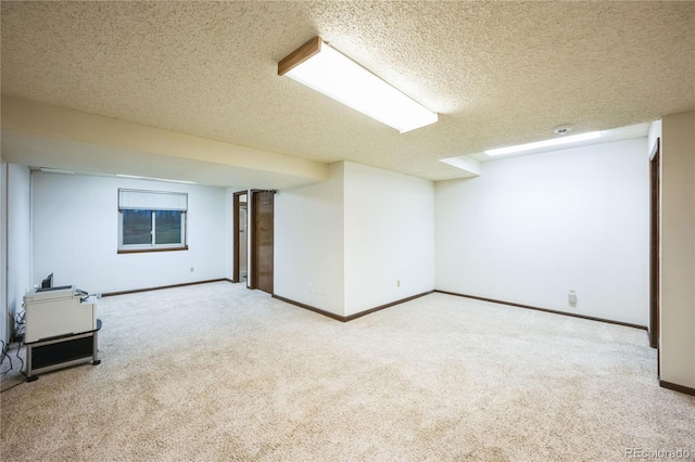 basement with a textured ceiling and carpet floors