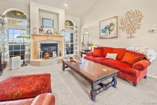 1060 Alta Vista Dr, Craig, CO 81625 - carpeted living room featuring arched walkways, a fireplace, vaulted ceiling, and baseboards