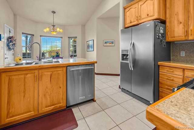 1060 Alta Vista Dr, Craig, CO 81625 - kitchen with appliances with stainless steel finishes, a sink, a chandelier, light tile patterned floors, and backsplash