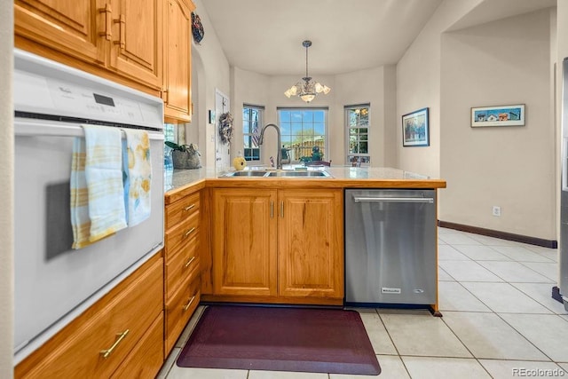 1060 Alta Vista Dr, Craig, CO 81625 - kitchen with dishwasher, a sink, a peninsula, a chandelier, and brown cabinetry