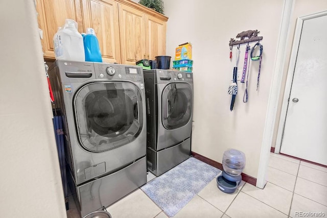 1060 Alta Vista Dr, Craig, CO 81625 - clothes washing area with washing machine and dryer, cabinet space, light tile patterned floors, and baseboards