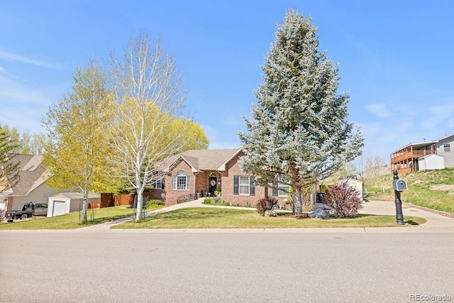 1060 Alta Vista Dr, Craig, CO 81625 - view of front of property with a front yard, concrete driveway, and brick siding