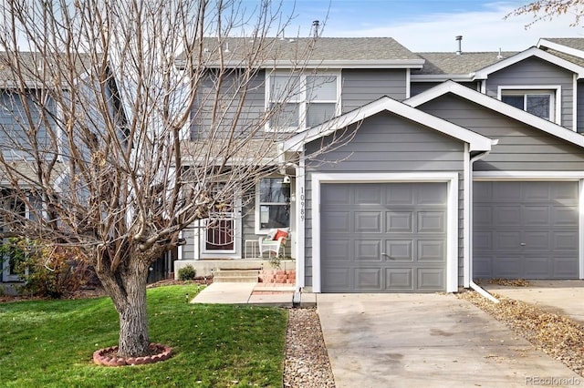 traditional-style home with a garage, roof with shingles, driveway, and a front lawn