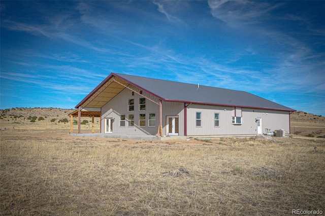 rear view of property with cooling unit