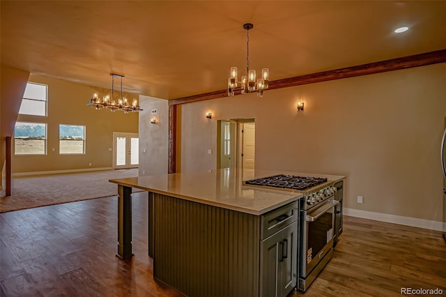 kitchen featuring a center island, dark hardwood / wood-style flooring, decorative light fixtures, a kitchen bar, and high end stainless steel range