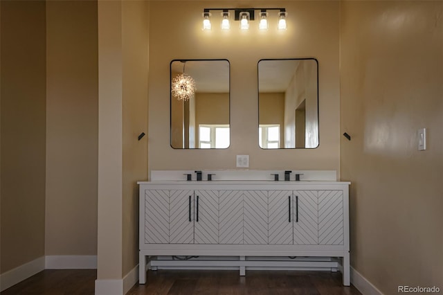 bathroom with vanity, a chandelier, and hardwood / wood-style flooring