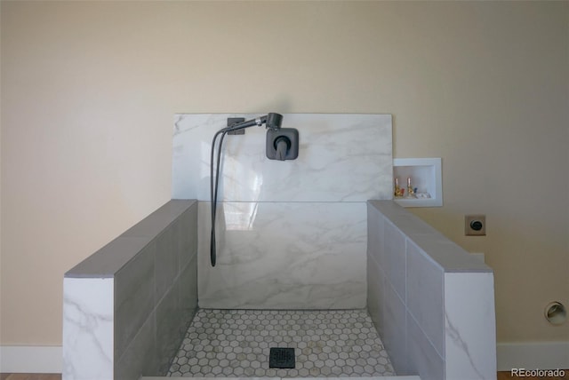 bathroom featuring tile patterned floors and tiled shower