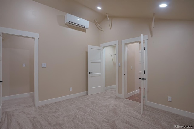 unfurnished bedroom with light carpet, high vaulted ceiling, and a wall mounted AC