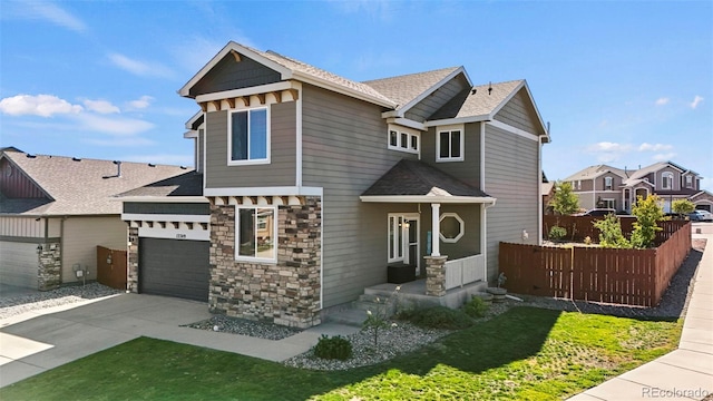 craftsman-style home featuring a front yard and a garage