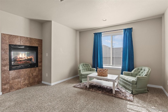 living area featuring a fireplace and carpet