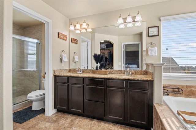 full bathroom with vanity, separate shower and tub, and toilet