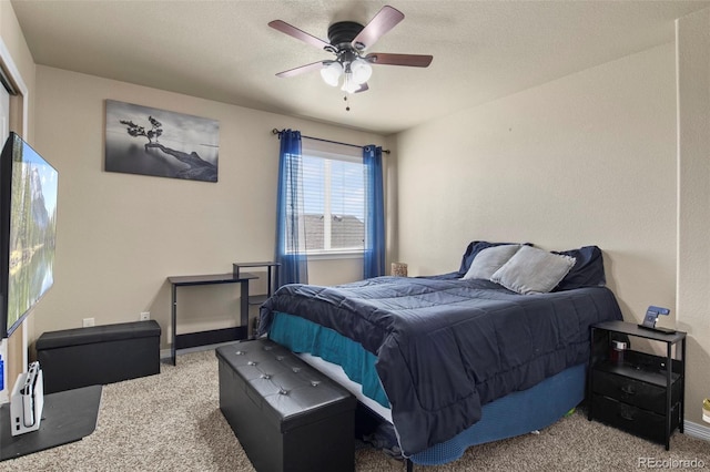 carpeted bedroom featuring ceiling fan and a textured ceiling