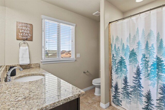 bathroom with vanity, toilet, and tile patterned flooring