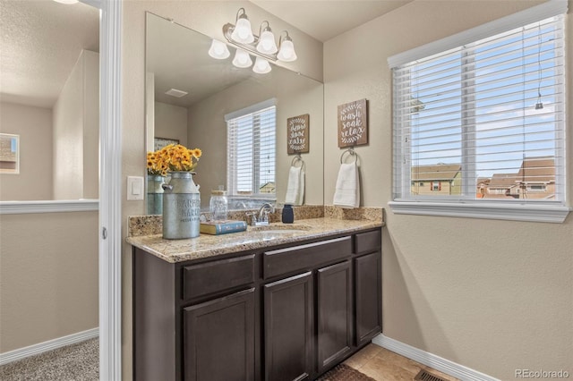 bathroom featuring vanity, a textured ceiling, and tile patterned flooring