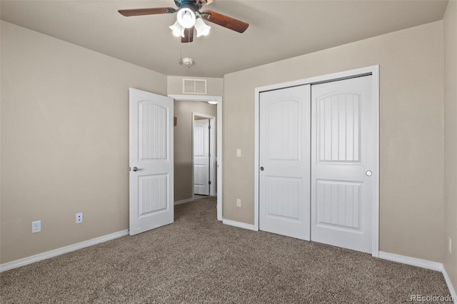 unfurnished bedroom featuring carpet floors, a closet, and ceiling fan