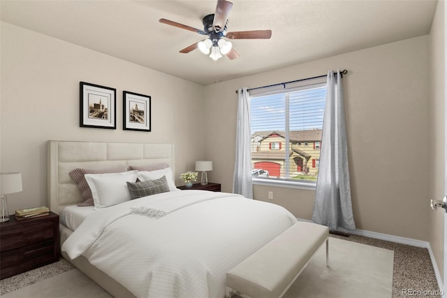 bedroom with ceiling fan and light colored carpet