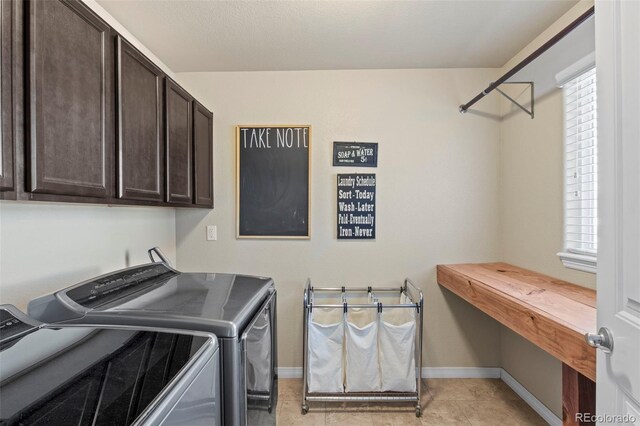 laundry area with cabinets, independent washer and dryer, and light tile patterned floors