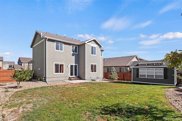 back of house featuring a patio area, a storage unit, and a lawn